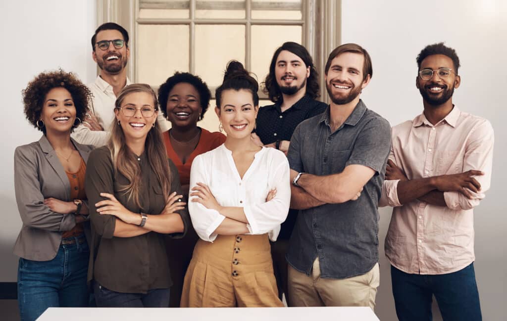 Happy, diverse and smiling startup entrepreneurs standing together showing teamwork goals.